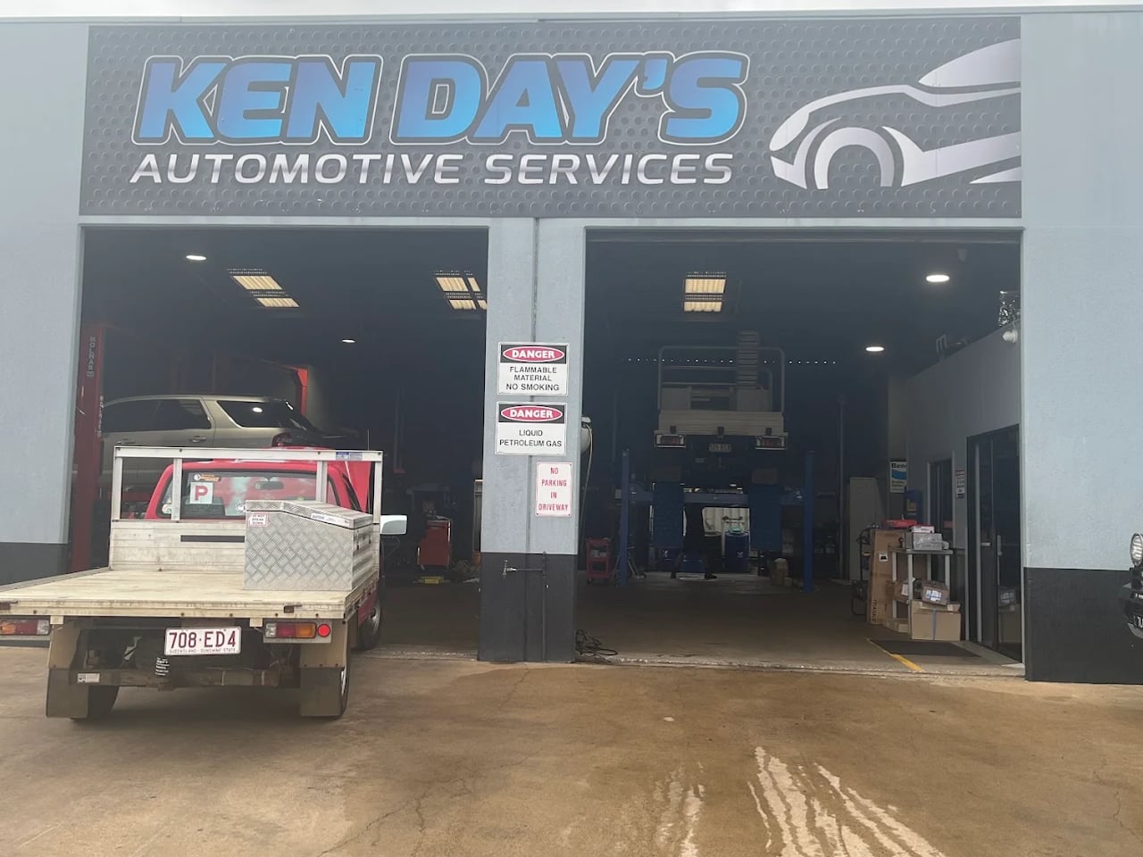 The Ken Day's Automotive Services workshop on Woondooma Street, signage above both open workshop bays